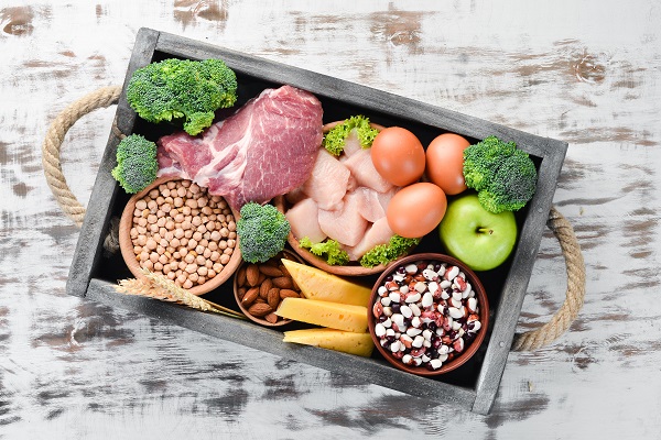 Raw meats, veggies, and beans in a box