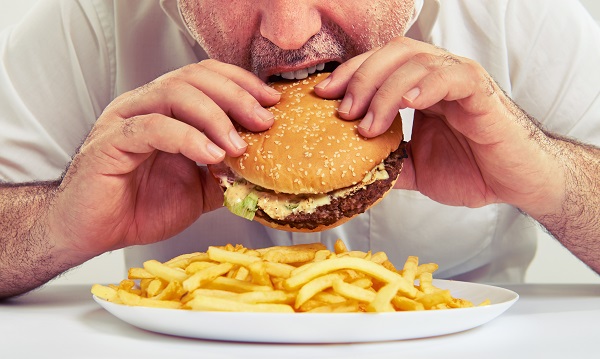Man eating burger and fries