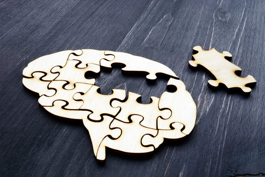 Brain Puzzle pieces on wooden table