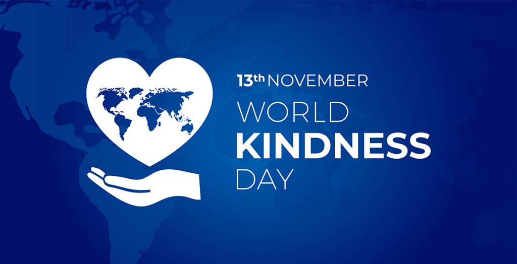 World Kindness Day blue banner with a hand holding up a heart-shaped world