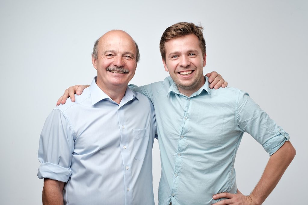 Caucasian father and son smiling for the camera