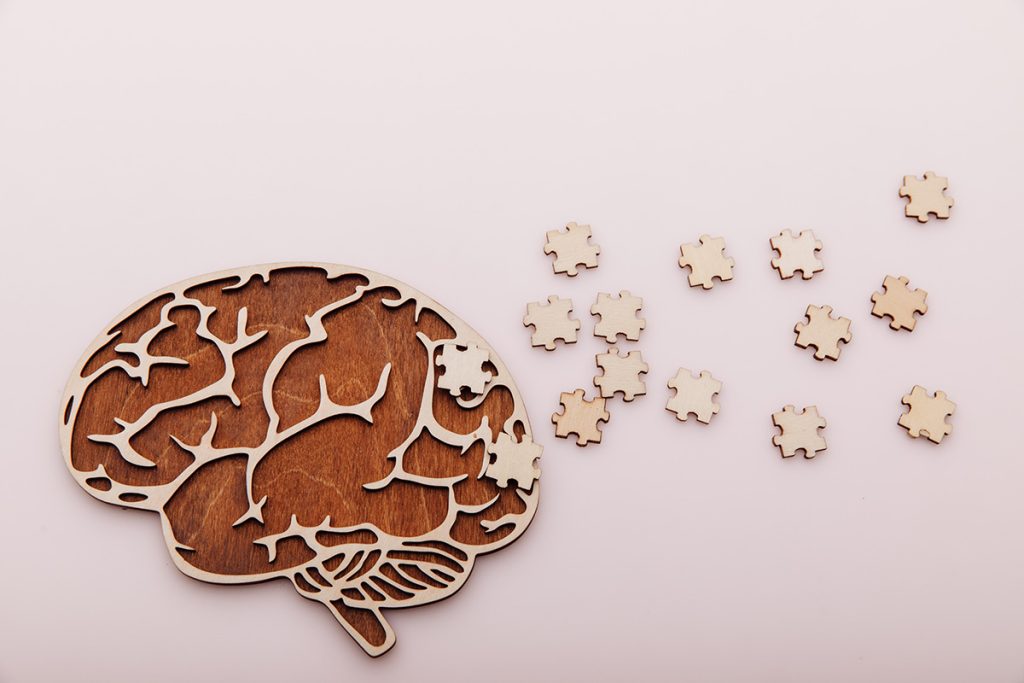 Brain puzzle with puzzle pieces scattered to the right side