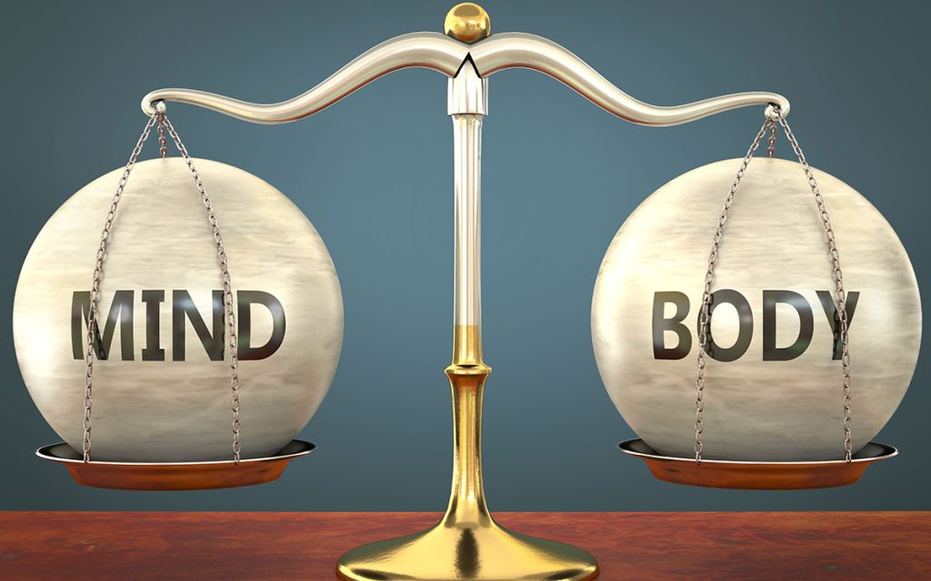 Two balls labeled "Mind" & "Body" equally balanced on a scale