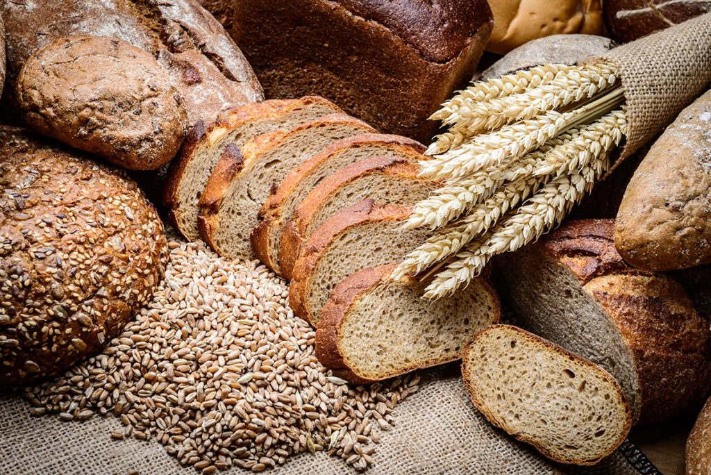 Whole grain breads spread out on a surface