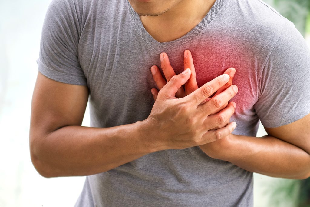 Man clutching his chest due to heart pain