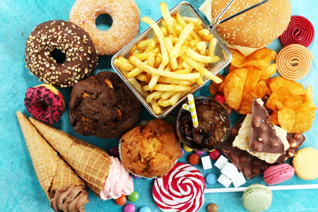 Top view of a myriad of unhealthy foods