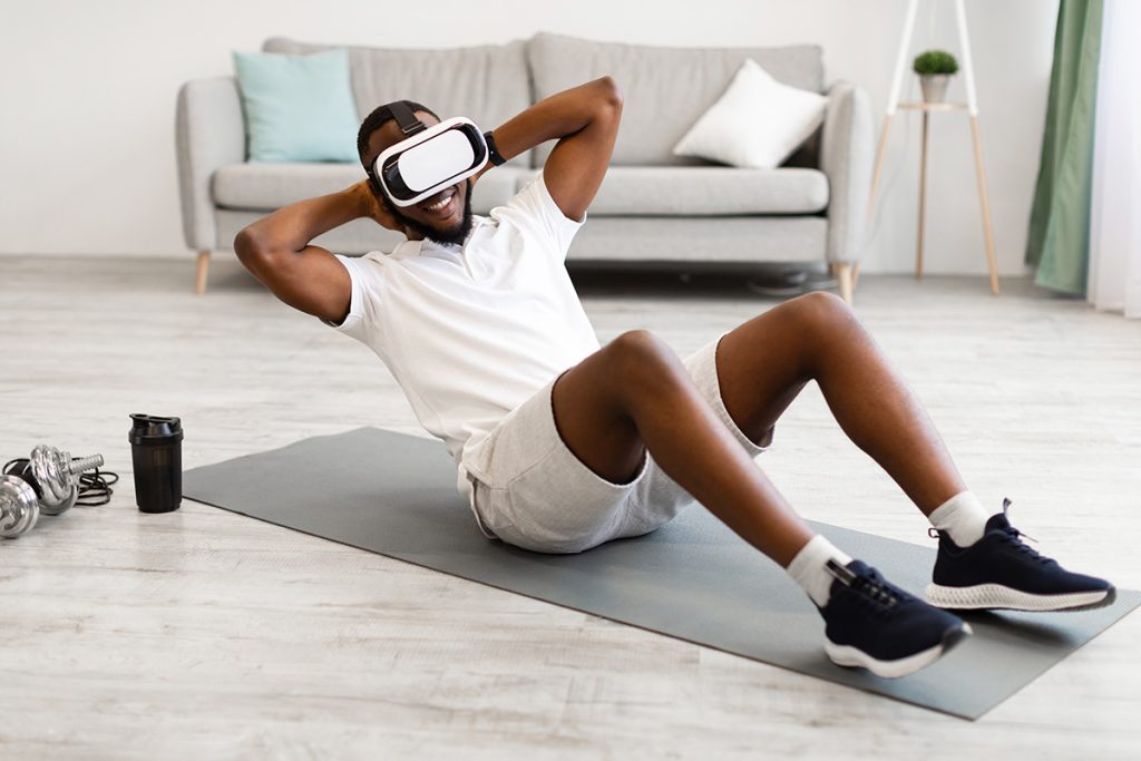 A man doing sit-ups while viewing something on VR