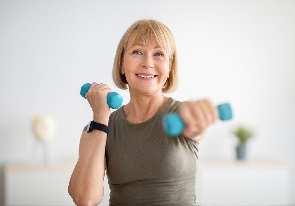 Older woman exercising and looking at the camera