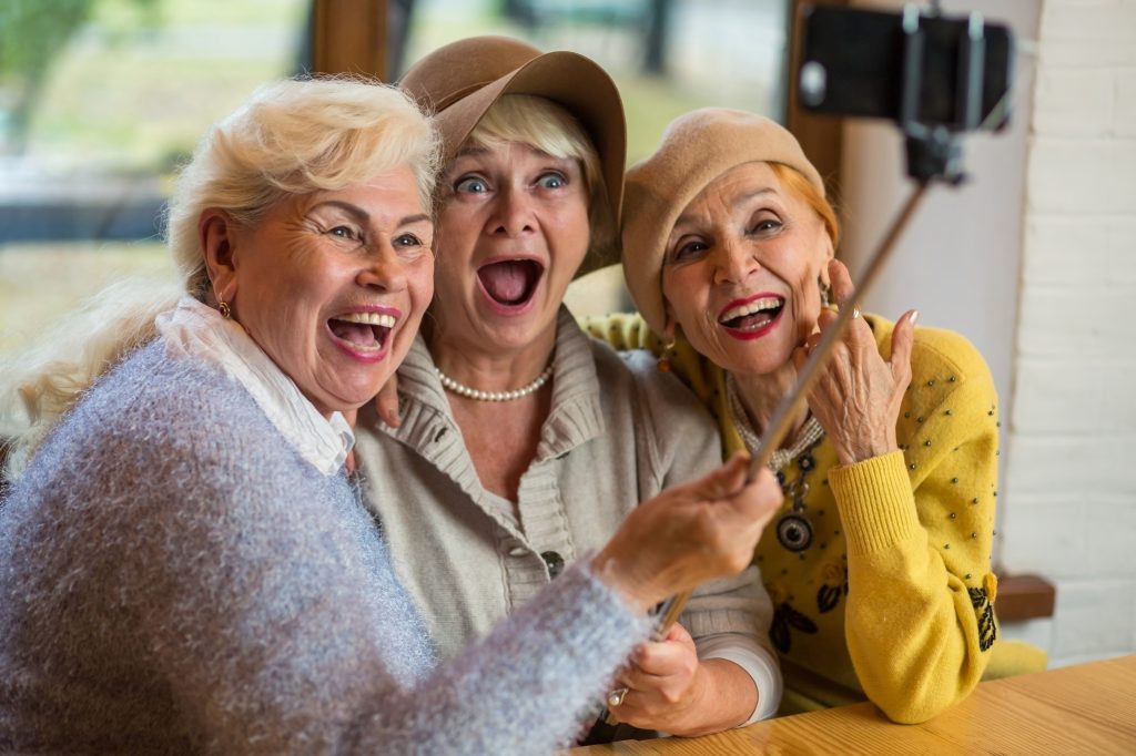 Three older women trying to take a selfie