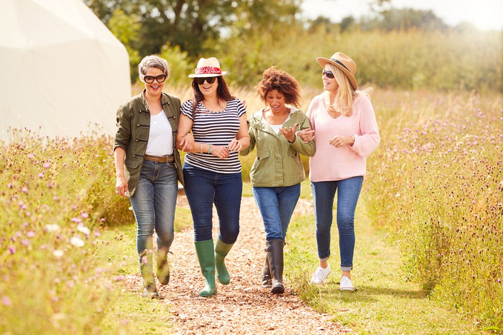 A group of middle age women taking a leisurely stroll 