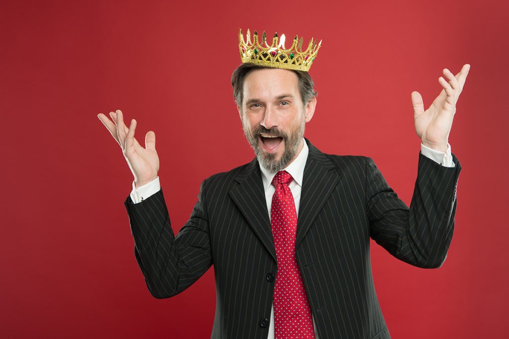 Narcissistic man posing with a crown
