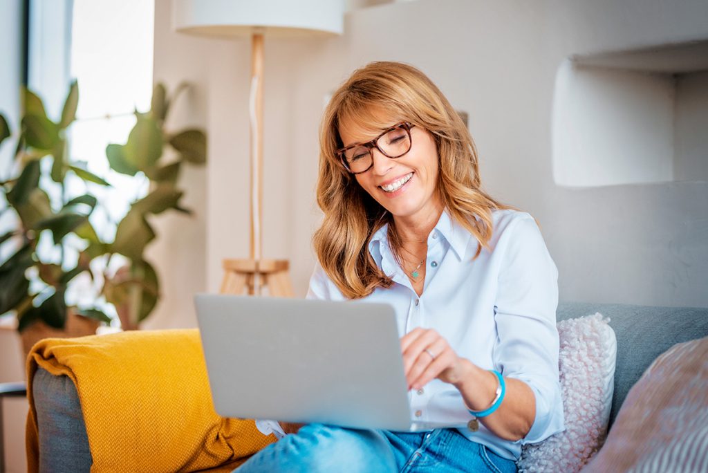 Woman smiling while on her laptop