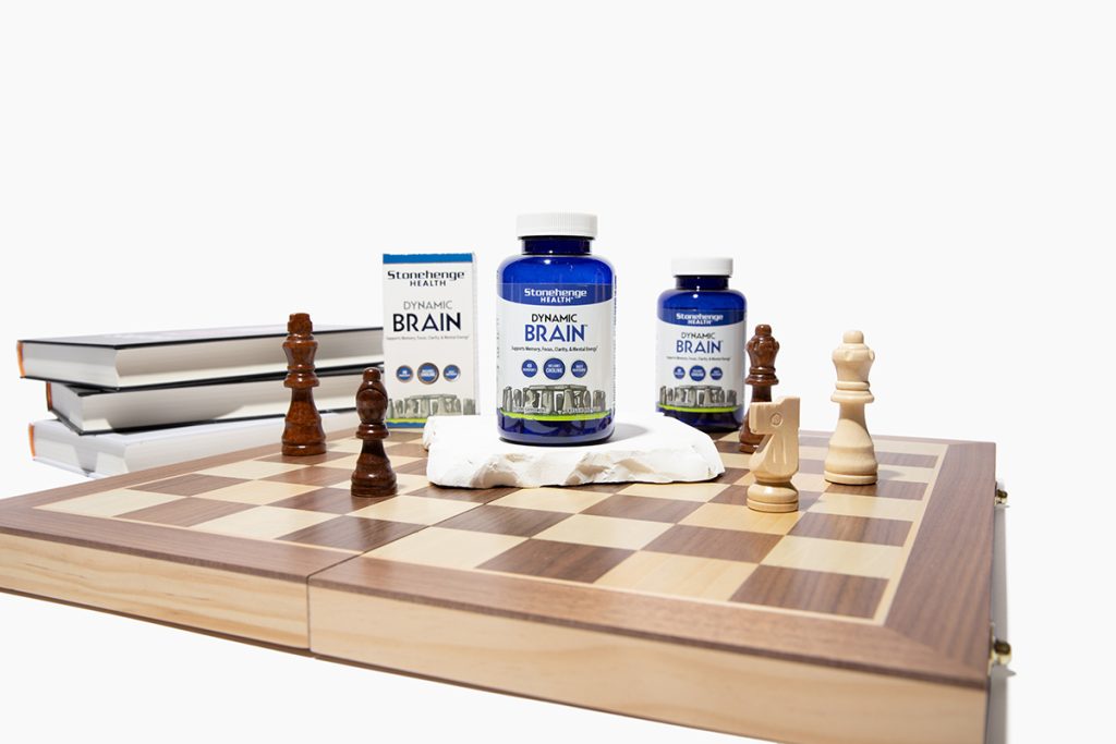 dynamic brain supplement on with a chess set and books in background