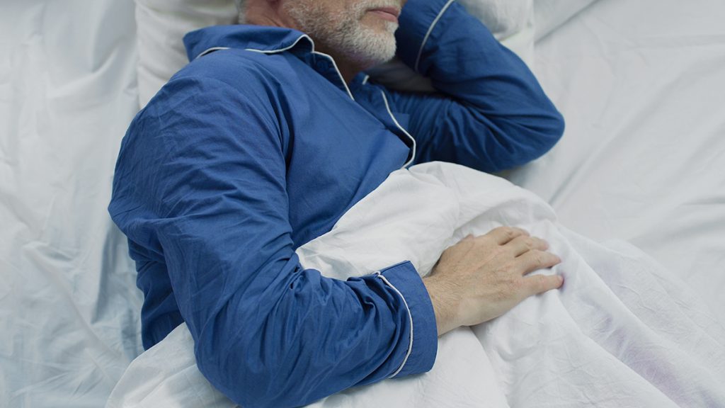Old man sleeping in bed in the morning, recovery time and healthy sleep