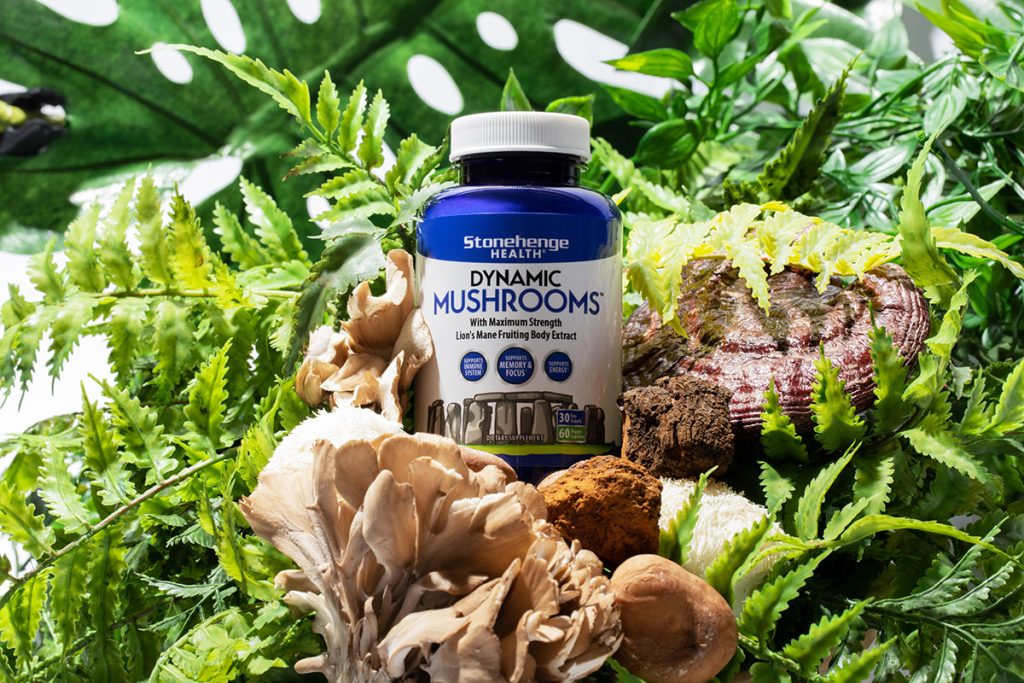 close up image of Dynamic Mushrooms supplement with foliage and mushrooms in background