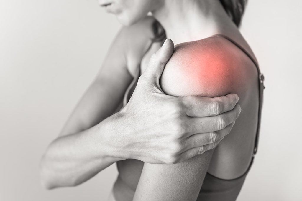 Woman suffering from muscle joint pain in her shoulder, arthritis,  Join inflammation concept.