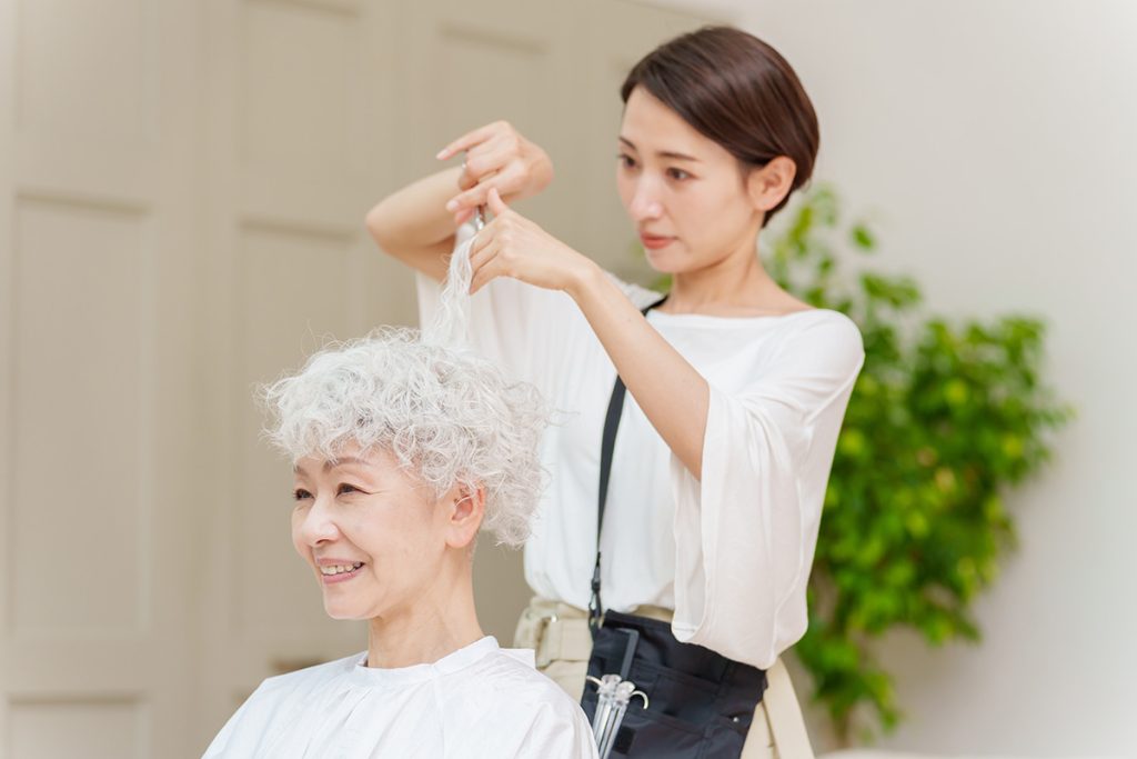 female hairdresser cutting a woman's hair