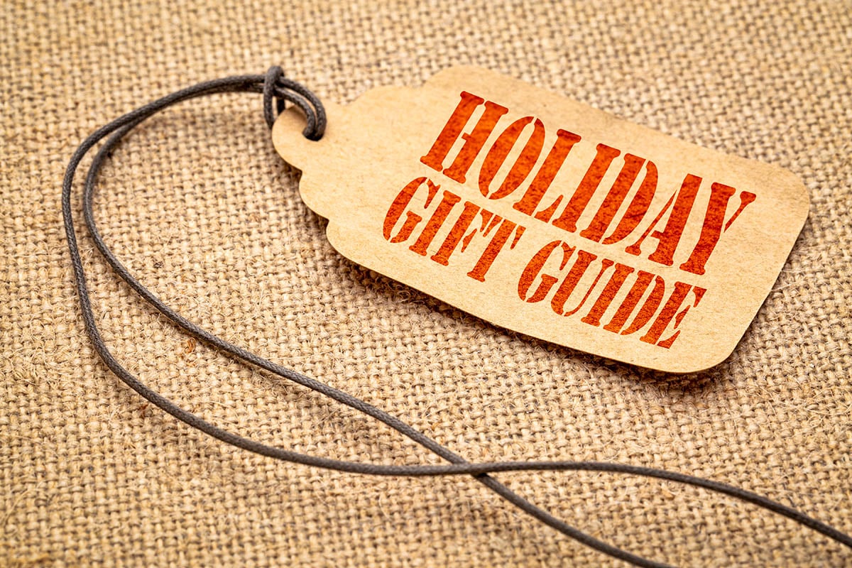 Holiday gift guide sign - a paper price tag with a twine against burlap canvas