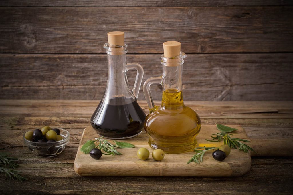 olive oil and balsamic vinegar on a wooden background