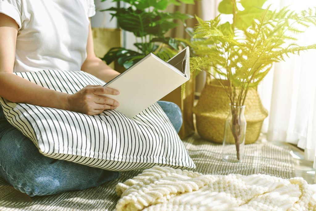 Woman chilling and reading in living room