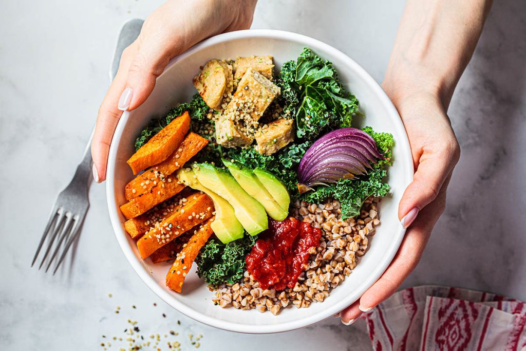 Healthy bowl with quinoa, avocado, and other vegetables. Balanced meal concept.