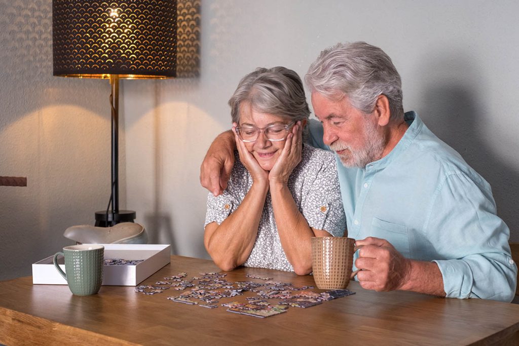 Older couple solving puzzles together