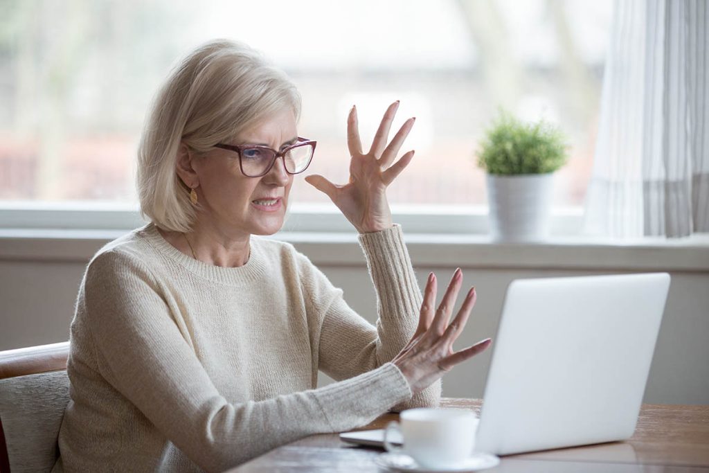 senior woman stressed and angry at her computer
