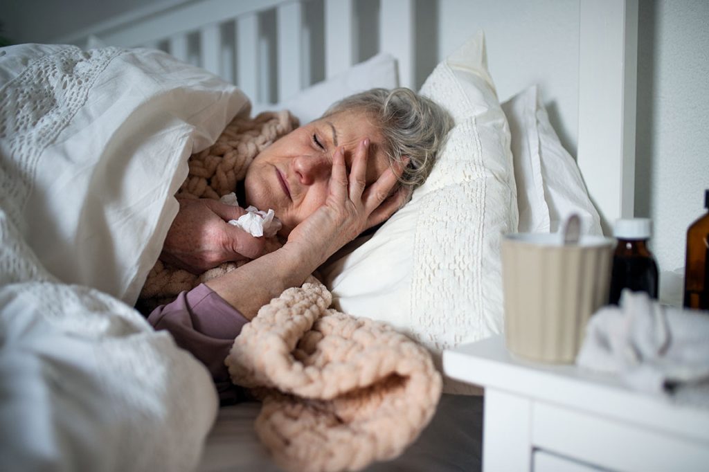 older woman sick in bed