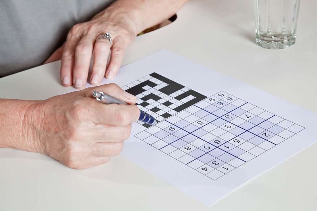 Portrait of mature woman playing sudoku puzzle.