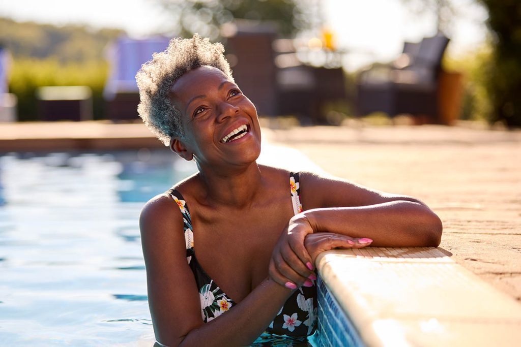 Smiling Senior Woman Relaxing In Swimming Pool