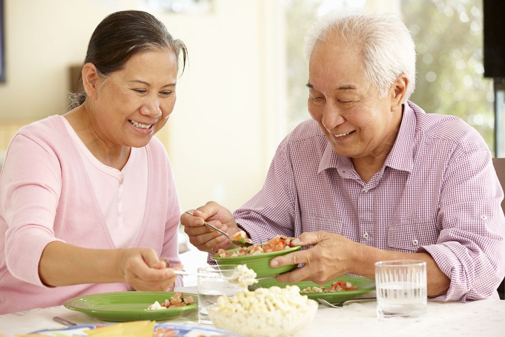 Senior couple sharing meal at home