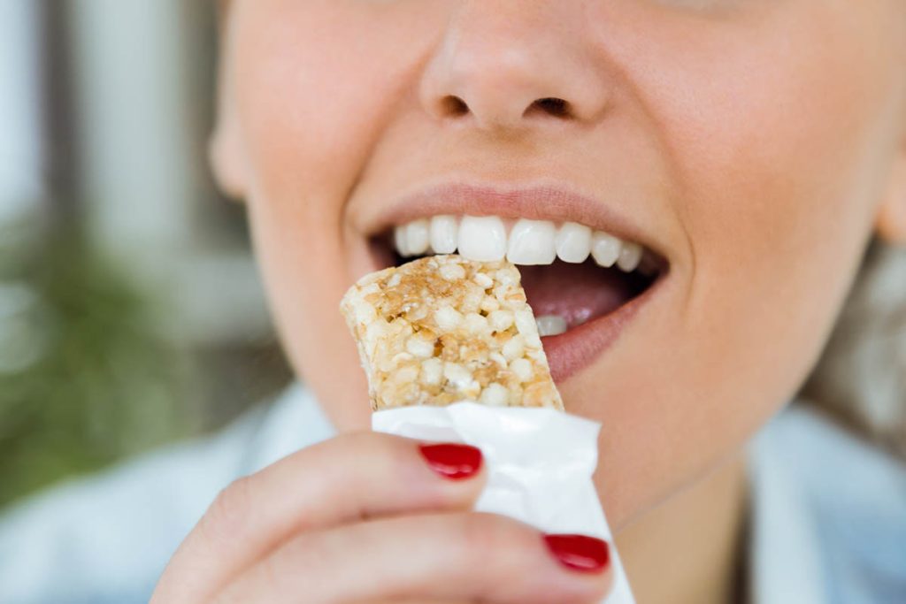 woman eating granola bar