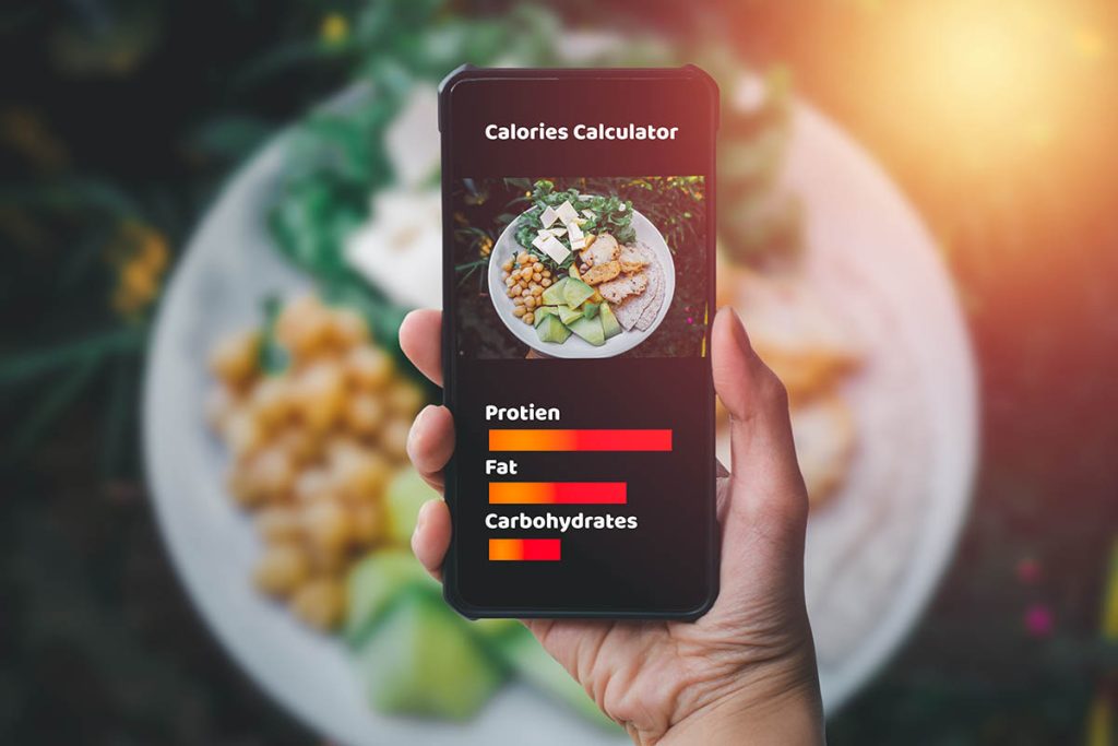 Smartphone and calories calculator concept.