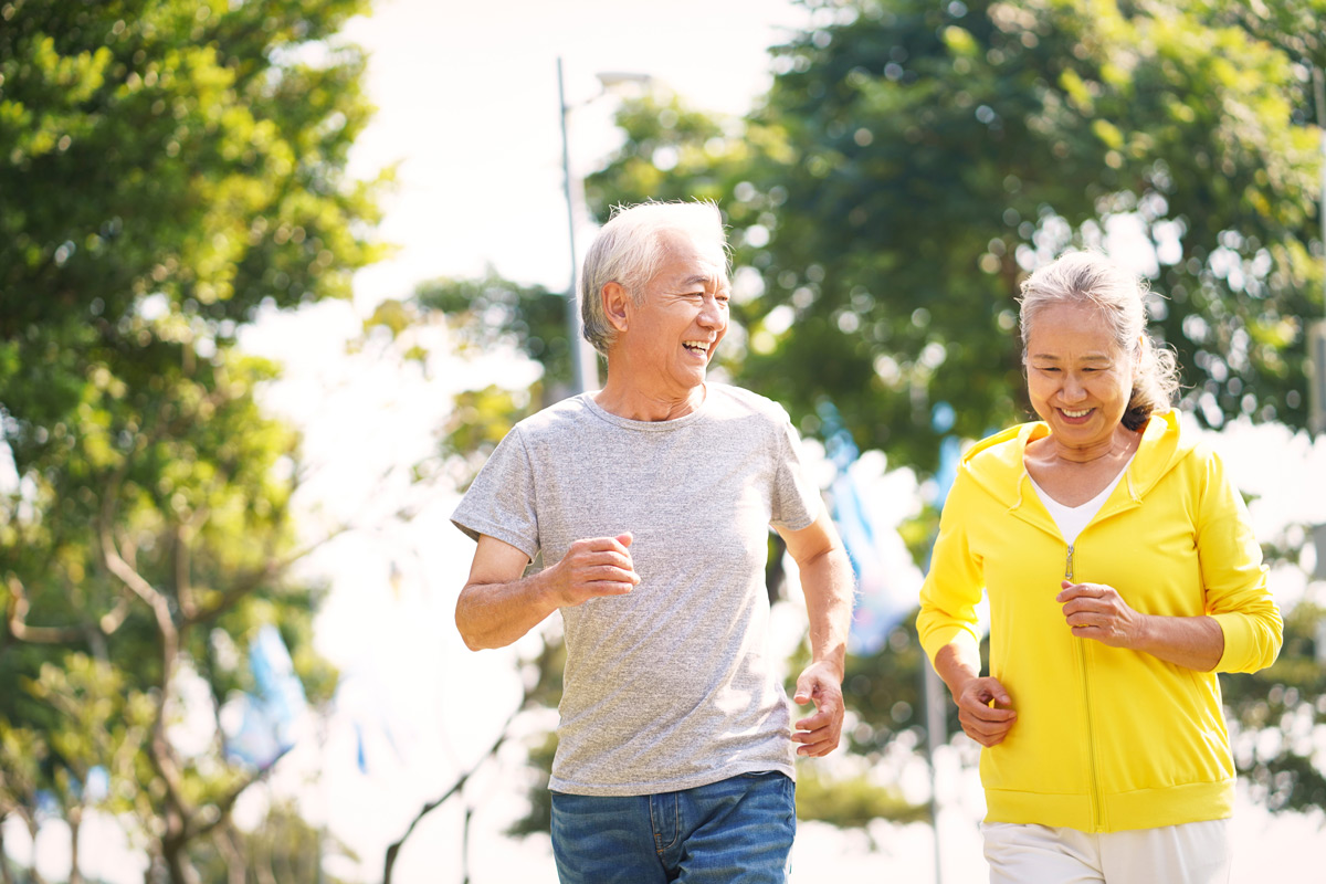 Older asian couple running together