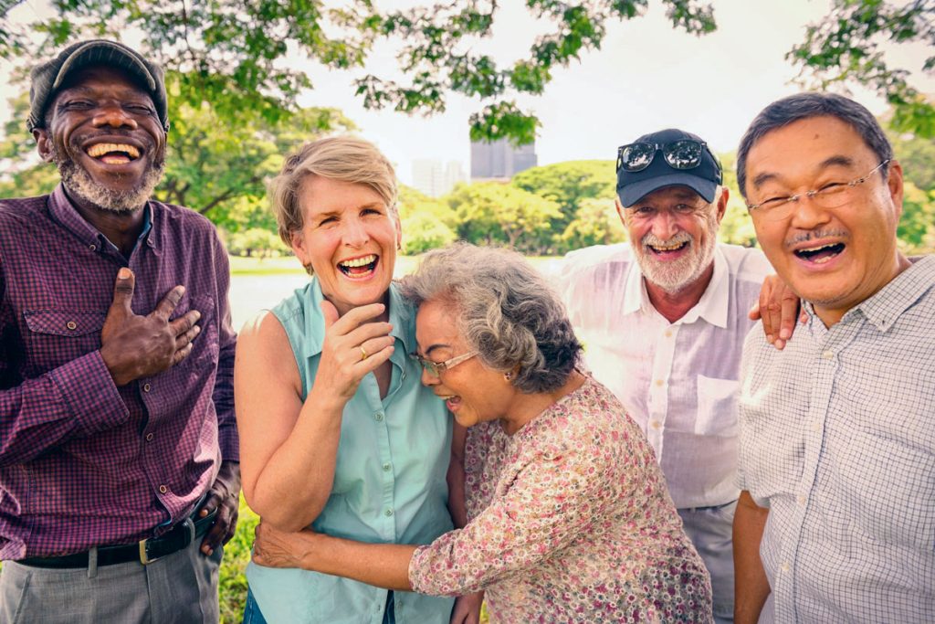 Diverse group of older friends laughing and enjoying time together