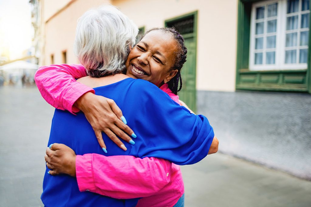 Multiracial senior women hugging each other - Elderly friendship and love concept