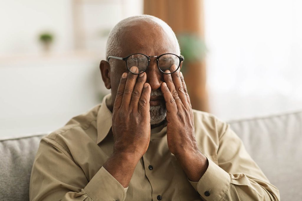 Senior Man Rubbing Tired Eyes Wearing Eyeglasses 