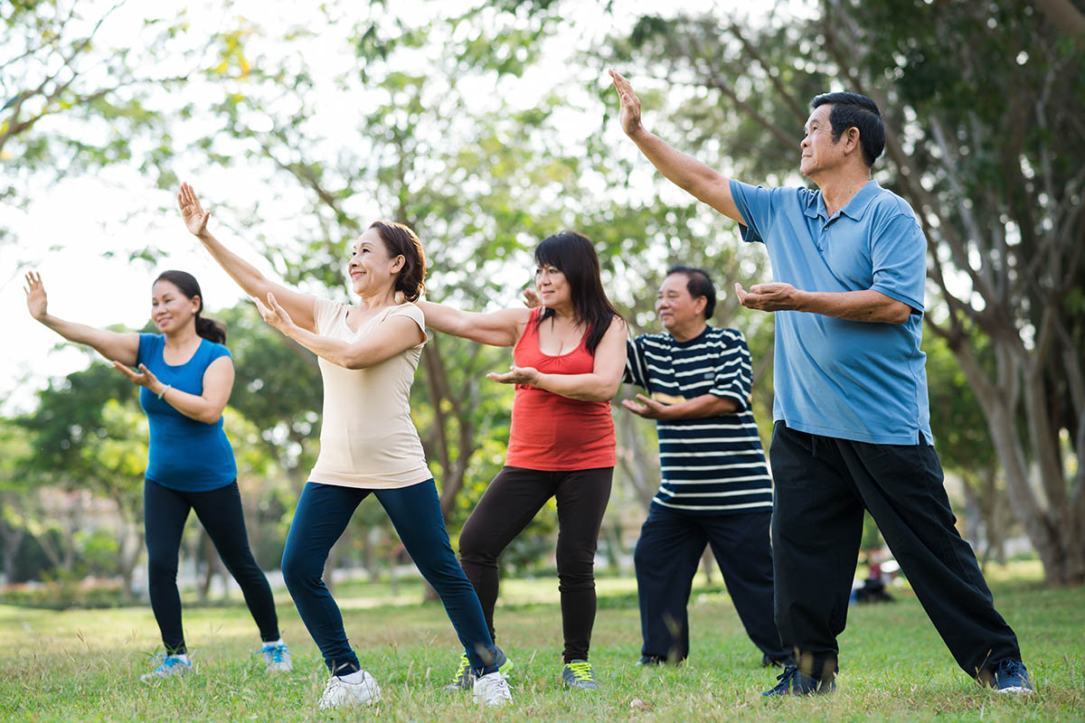 Elderly Asian people practicing Tai Chi together